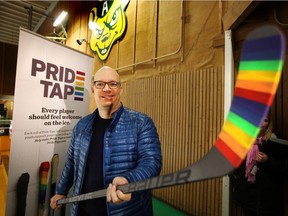 MacEwan University associate professor Kristopher Wells, pictured here with a Pride taped hockey stick in Edmonton in December, has lauded the Alberta NDP for its fall bill to outlaw conversion therapy.