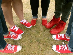 People wear red shoes as a symbol of support during an FASD Awareness Day carnival breakfast put on by the Calgary Fetal Alcohol Network Sunday, September 9, 2018.