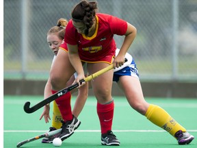 Nadia Izzo of the University of Calgary keeps the ball away from Cailean Meredith of the University of British Columbia during Canada West field hockey action at the University of Calgary in Calgary, Alta., on Saturday, Sept. 26, 2015. Lyle Aspinall/Calgary Sun/Postmedia Network