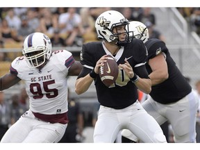 FILE - In this Saturday, Sept. 8, 2018, file photo, Central Florida quarterback McKenzie Milton (10) throws a pass as offensive lineman Wyatt Miller (78) blocks against South Carolina State defensive end Cordell Brown (95) during the first half of an NCAA college football game in Orlando, Fla.