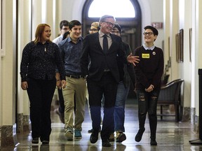 Education Minister David Eggen walks with students on his way to speak about the passing of Alberta's gay-straight alliance bill in Edmonton on Nov. 15, 2017.