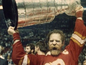 Calgary Flames' Lanny McDonald raises the Stanley Cup after defeating the Montreal Canadiens in Montreal on May 25, 1989.
