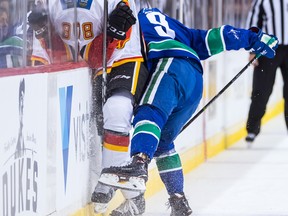 Calgary Flames' Dmitry Zavgorodniy, left, of Russia, is checked by Vancouver Canucks' Brendan Leipsic during the first period of a pre-season NHL hockey game in Vancouver, B.C., on Wednesday September 19, 2018. THE CANADIAN PRESS/Darryl Dyck ORG XMIT: VCRD103