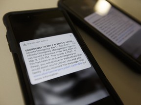 Photo of two Apple iPhones receiving the May 9, 2018 emergency alert test from the Alberta Emergency Management Agency in Edmonton on Wednesday, May 9, 2018.