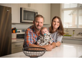 Jeffrey and Jennifer Best with baby Harrison in their new townhome at the Chalet No6 development by Hopewell Residential in Copperfield.