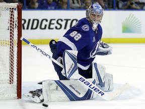 In this May 23, 2018, file photo, Tampa Bay Lightning goaltender Andrei Vasilevskiy watches the puck go past during the first period of Game 7 of the NHL Eastern Conference finals hockey playoff series against the Washington Capitals, in Tampa, Fla. (AP Photo/Chris O'Meara, File) ORG XMIT: FLCO105
