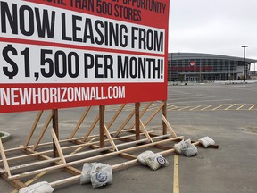A sign posted in the empty parking lot of the New Horizon Mall north of Calgary on Thursday, Sept. 20, 2018.