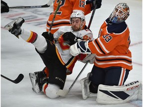 Calgary Flames Andrew Mangiapane (88) gets pushed into Edmonton Oilers goalie Cam Talbot (33) during pre-season NHL action at Rogers Place in Edmonton, September 29, 2018. Ed Kaiser/Postmedia