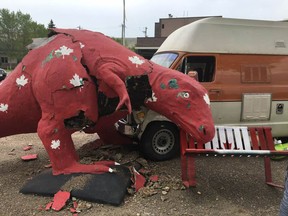 A dinosaur sculpture outside the post office in Drumheller was damaged following a two-vehicle collision.