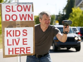 Garrison Wood resident, Kris Norman is in favor of the 30 km/h speed limit limit after monitoring traffic in his community in Calgary on Wednesday September 5, 2018. Darren Makowichuk/Postmedia