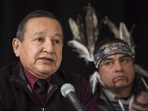 Grand Chief of the Union of British Columbia Indian Chiefs, Stewart Phillip, speaks at a news conference with indigenous leaders and politicians opposed to the expansion of the Trans Mountain oil pipeline in Vancouver on April 16, 2018. Behind is William George, a member of the Tsleil-Waututh First Nation.