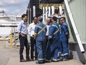 Prime Minister Justin Trudeau meets with workers as he visits Kinder Morgan in Edmonton on June 5, 2018.