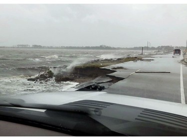 In this photo provided by Jordan Guthrie, wind and water from Hurricane Florence damages the highway leading off Harkers Island, N.C. on Friday, Sept. 14, 2018.  (Jordan Guthrie via AP) ORG XMIT: NY111