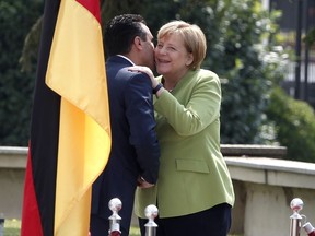 German Chancellor Angela Merkel, right, is welcomed by Macedonian Prime Minister Zoran Zaev upon her arrival at the government building in Skopje, Macedonia, Saturday, Sept. 8, 2018. German Chancellor Angela Merkel arrived to Macedonia Saturday, three weeks before the referendum for Macedonia's deal with neighboring Greece to change the country's name to "North Macedonia" that would facilitate country's EU and NATO accession.