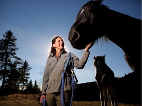 Director of Free Spirit Sanctuary Dr. Sandie Hucal with some of the horses at the animal sanctuary near Cochrane, Ab., on Sunday October 21, 2018.