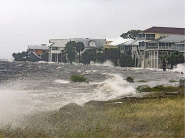SHELL POINT BEACH, FL - OCTOBER 10: The storm surge and waves from Hurricane Michael batter the beachfront homes on October 10, 2018 in the Florida Panhandle community of Shell Point Beach, Florida. The hurricane is forecast to hit the Florida Panhandle at a possible category 4 storm.