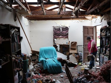 PANAMA CITY, FL - OCTOBER 11:  Amanda Logsdon begins the process of trying to clean up her home after the roof was blown off by the passing winds of hurricane Michael on October 11, 2018 in Panama City, Florida. The hurricane hit the Florida Panhandle as a category 4 storm.