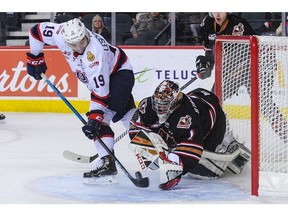 CALGARY, AB - OCTOBER 14: Jake Leschyshyn #19 of the Regina Pats takes a shot on Carl Stankowski #1 of the Calgary Hitmen during a WHL game at the Scotiabank Saddledome on October 14, 2018 in Calgary, Alberta, Canada.