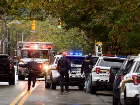 Police rapid response team members respond to the site of a mass shooting at the Tree of Life Synagogue in the Squirrel Hill neighborhood on October 27, 2018 in Pittsburgh, Pennsylvania. According to reports, at least 12 people were shot, 4 dead and three police officers hurt during the incident. The shooter surrendered to authorities and was taken into custody.