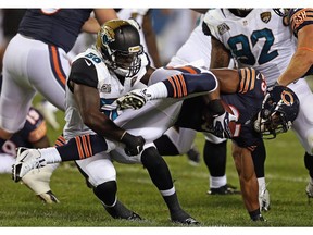 CHICAGO, IL - AUGUST 14: Ka'Deem Carey #25 of the Chicago Bears is tackled by Allen Bradford #58 of the Jacksonville Jaguars during the third quarter of a preseason game at Soldier Field on August 14, 2014 in Chicago, Illinois.