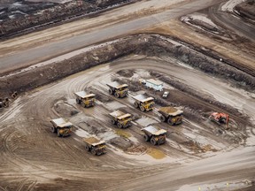 Heavy haulers sit parked at the Suncor Energy Inc. Millennium mine at the Athabasca oil sands near Fort McMurray. Suncor earnings are to be released Oct. 31.