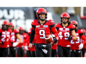 Quarterback Nick Arbuckle of the Calgary Stampeders runs onto the field during player introductions before facing the BC Lions in CFL football on Saturday, October 13, 2018. Al Charest/Postmedia