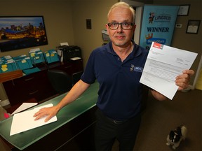 Fred Hamilton of Lincoln Exterior Renovations holds up his proposed 2019 property assessment notice. Calgary saw the biggest jump in commercial tax rates among major Canadian cities, rising 9.5 per cent in 2018.