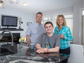 Andy and Trish Meier with their son Aedan, 16, in their new home in Nolan Hill.