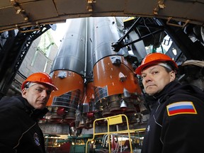 Canadian astronaut David Saint-Jacques, left, pictured with Russian cosmonaut Oleg Kononenko in front of the Soyuz booster rocket on Oct. 9, 2018. The rocket would fail on Thursday, Oct. 11, causing two other astronauts to make an emergency landing in Kazakhstan.