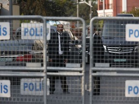 Security personnel guarding Saudi Arabia's consulate are seen behind barriers blocking the road leading to the diplomatic mission, in Istanbul, Monday, Oct. 22, 2018. Saudi Crown Prince Mohammed bin Salman called the son of Jamal Khashoggi, the kingdom announced early Monday, to express condolences for the death of the journalist killed at the Saudi Consulate in Istanbul by officials that allegedly included a member of the royal's entourage.