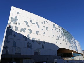 Workers carry out finishing touches, including window cleaning, at Calgary's new Central Library. The new building is set to open Nov. 1.