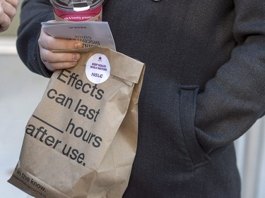 A customer carries his purchase after leaving the Nova Scotia Liquor Corporation cannabis store in Halifax on Oct. 17, 2018. Residents can make their purchases at 12 Nova Scotia Liquor Corporation stores across the province and online.