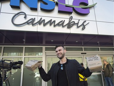 Isaac Langille displays his purchases as he leaves the Nova Scotia Liquor Corporation cannabis store in Halifax on Oct. 17, 2018. Residents can make their purchases at 12 Nova Scotia Liquor Corporation stores across the province and online.