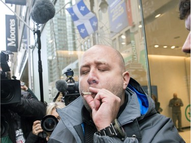 Hugo Senecal smokes his first legal cannabis joint after buying it from a government store in Montreal, Wednesday, October 17, 2018.