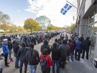 Hundreds of people line up at a government cannabis store Wednesday, October 17, 2018 in Montreal as the legal sale of cannabis begins in Canada.THE CANADIAN PRESS/Ryan Remiorz ORG XMIT: RYR103