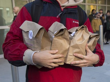 A customer carries his purchases as he leaves the Nova Scotia Liquor Corporation cannabis store in Halifax on Oct. 17, 2018. Residents can make their purchases at 12 Nova Scotia Liquor Corporation stores across the province and online.