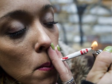 Krissy Calkins lights a joint at a "Wake and Bake" legalized marijuana event in Toronto on Wednesday, October 17, 2018.