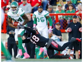 Calgary Stampeders Wynton McManis, right, tries to tackle Saskatchewan Roughriders Jordan Williams-Lambert during CFL action at McMahon Stadium in Calgary, Alta.. on Saturday. Photo by Leah hennel/Postmedia.