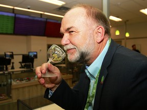 Jim Riege, senior director at Calgary Coop Cannabis, sniffs a product on display at the retail store in southwest Calgary on Thursday, Oct. 25, 2018.