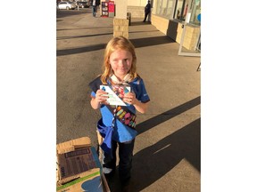 Nine-year-old Elina Childs poses as she sells Girl Guide Cookies outside a cannabis store in Edmonton on Wednesday, Oct. 17, 2018 in this handout photo. She's being called one smart cookie. As people lined up to buy marijuana at one of six Edmonton cannabis stores that opened Wednesday, there was a small entrepreneur in the crowd. Nine-year-old Elina Childs had a wagon full of Girl Guide cookies for sale.
