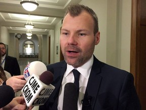 Saskatchewan Energy Minister Dustin Duncan talks with reporters at the provincial legislature, in Regina on Thursday, Nov. 17, 2016. Saskatchewan will have to wait until next spring for the province's Appeal Court to rule on whether Ottawa can impose a carbon tax.THE CANADIAN PRESS/Jennifer Graham