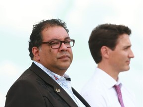 Calgary Mayor Naheed Nenshi listens with Prime Minister Justin Trudeau in this file photo from July 6, 2018 at the Calgary International Airport.