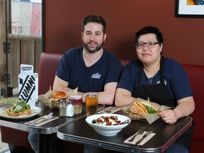 Owner Jeremy Milligan (L) and chef Wall Wo relax at Alumni Sandwich and Liquor Bar on 17 Ave SW in Calgary on Thursday, September 20, 2018. Jim Wells/Postmedia