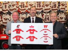 (L-R) Mike Rogers, Jamie Macoun and MIke Vernon pose with artwork at Adrenaline Source for Sports in Calgary on  Wednesday, October 10, 2018. The Calgary Hitmen announced they will play a number of games in the Corral called "The Corral Series" and they will wear replica jerseys of the teams that played in the Calgary Corral. Jim Wells/Postmedia