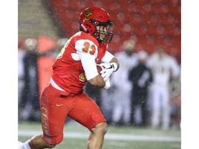 Calgary Dinos running back Robinson Rodrigues takes a hand off during U Sports Canadian college football action between the University of Calgary Dinos and the Manitoba Bisons in Calgary on Friday, October 12, 2018. Jim Wells/Postmedia