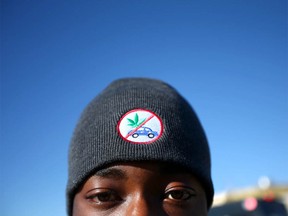 Raqeeb Popoola, a grade 12 student at Robert Thirsk High School in Calgary wears a hat with a no marijuana and no driving message. The Calgary Police Checkstop bus made a stop at two Calgary High Schools to educate and engage students on the first day of legailsation on Wednesday, October 17, 2018. Jim Wells/Postmedia