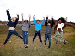 (L-R) Gerrit Surette, Nevaeh Lee, Daniel Mercader, Theo Minoso, Sophie Loding all grade 6 students at St Peter Elementary School, pose on the school playground in southeast Calgary on Thursday, October 18, 2018.. St Peter Elementary is one of four finalists in the Kraft Heinz Power Play contest to win $250,000 for a new playground, right now they have nothing. Jim Wells/Postmedia