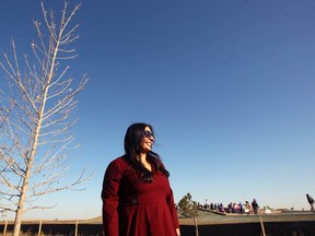Namrita Rattan, Manmeet Bhullar's wife, poses with a tree planted in his Bhullar's name, during the official opening of Manmeet Singh Bhullar Park in northeast Calgary on Saturday, October 20, 2018. Bhullar was the first turbaned Sikh to hold a cabinet position in the provincial government. Jim Wells/Postmedia