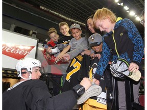 Pittsburgh Penguins Sidney Crosby signs autographs following practice in Calgary on Wednesday. Photo by Jim Wells/Postmedia.