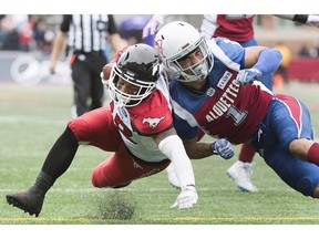 Calgary Stampeders' Terry Williams, left, evades a tackle from Montreal Alouettes' Branden Dozier to score a touchdown during second half CFL football action in Montreal, Monday.